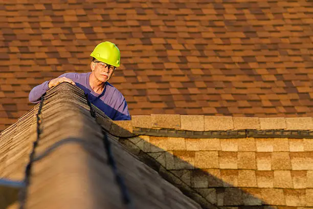 MJ roofing inspector assessing residential roofing